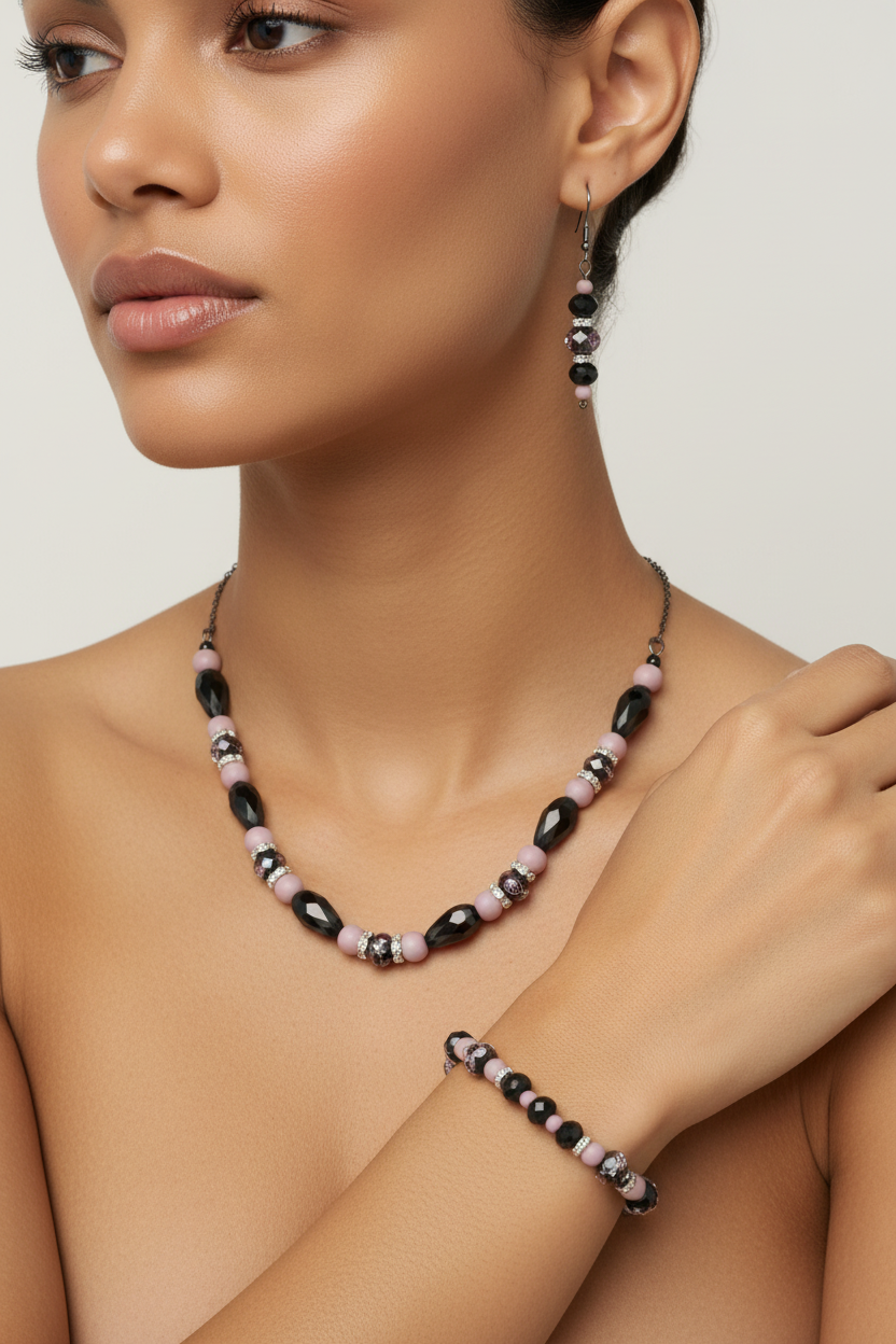 Black crystal and pink bead jewelry set on tan model