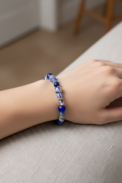 Blue beaded bracelet on model's wrist